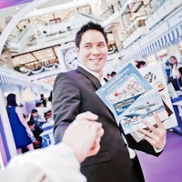 a man in a suit is shaking hands with a book