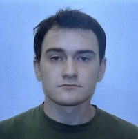 a man in a green shirt is posing for a photo