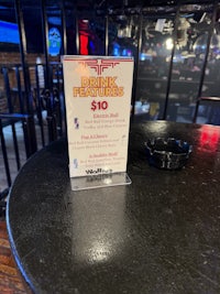 a ticket is sitting on a table in a bar