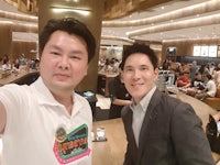 a man and a woman taking a selfie in a restaurant
